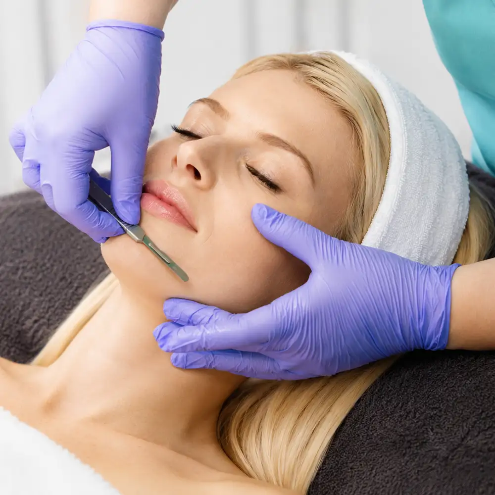 Licensed esthetician performing professional dermaplaning treatment at Refresh Medical in Rochester NY